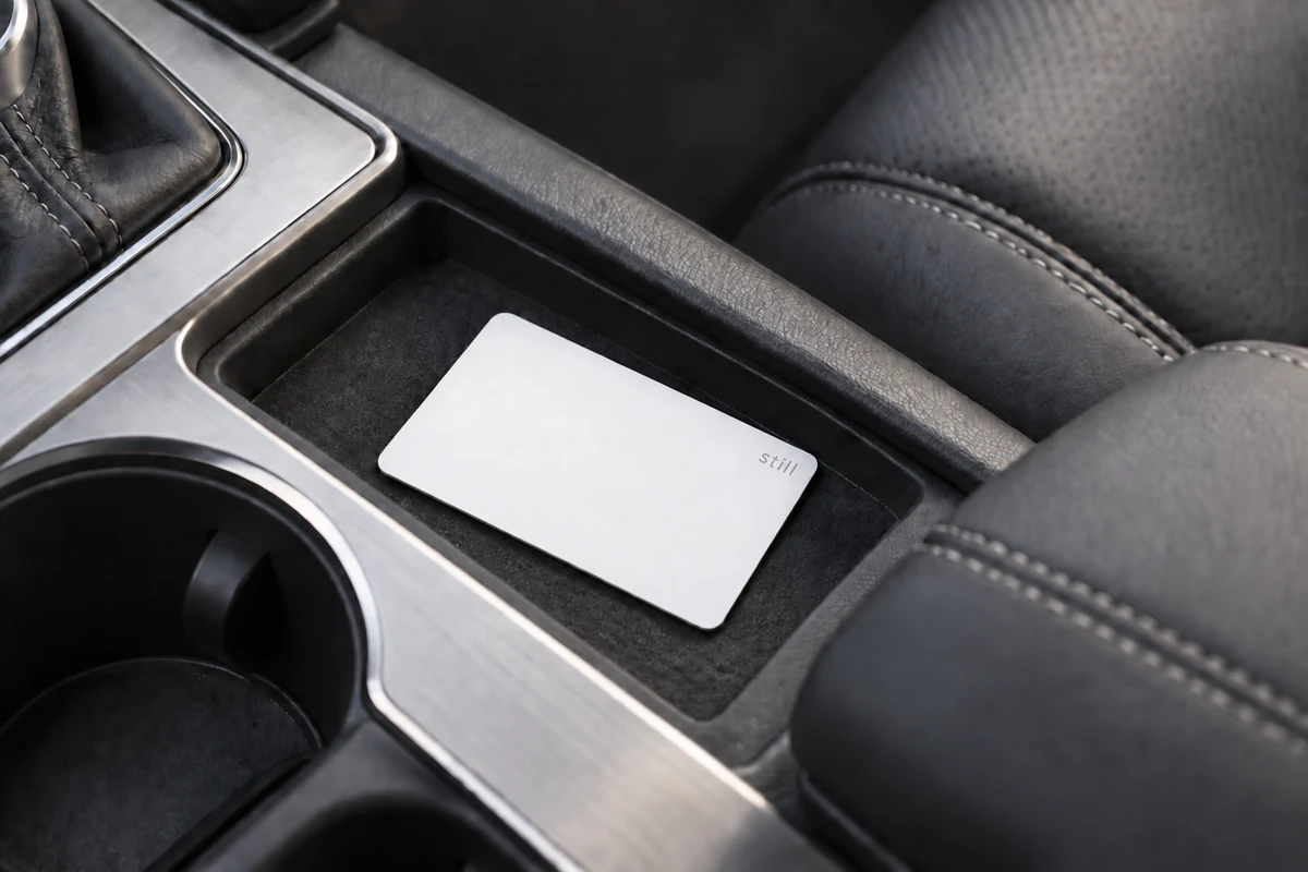 White Still Card in the center console of a neutral gray car interior